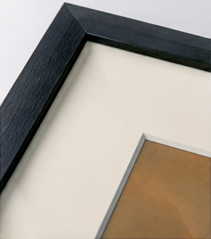 Black frame corner with a cream mount, shown at an angle