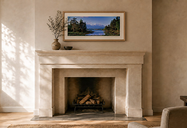 Exhibition size framed print hanging above a fireplace